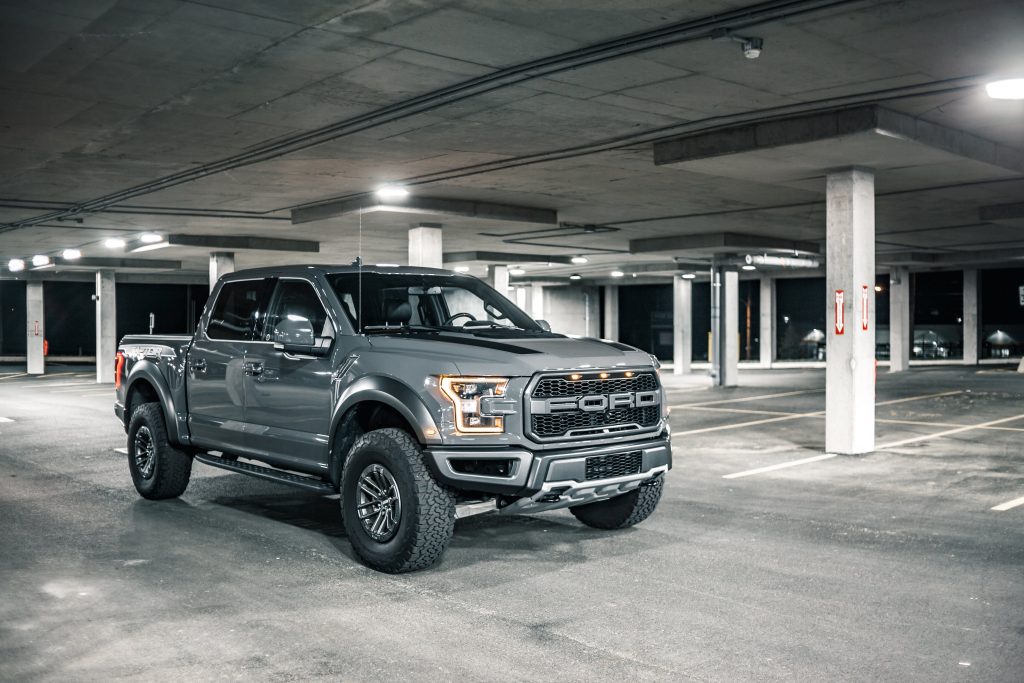 A gray Ford pickup parked in a covered parking lot